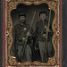 [Two unidentified soldiers in Union shell jackets and forage caps with cartridge pouches, cap boxes, and bayonet scabbards; one soldier in Co. C 85th regiment cap; other soldier has holstered pepperbox revolver] (LOC)