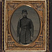 [Unidentified soldier in Union uniform with bayoneted musket in front of painted backdrop showing military camp] (LOC)