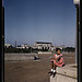 Little girl in a park with Union Station in the background, Washington, D.C.  (LOC)