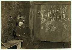 Vance, a Trapper Boy, 15 years old. Has trapped for several years in a West Va. Coal mine. $.75 a day for 10 hours work. All he does is to open and shut this door: most of the time he sits here idle, waiting for the cars to come ... (LOC)