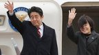 Japanese Prime Minister Shinzo Abe and his wife Akie, wave as they leave Tokyo International Airport on January 16, 2013, en route to Hanoi
