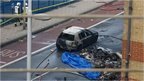Debris and a burned out car are pictured at the scene of a helicopter crash in Vauxhall