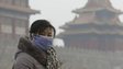 A visitor wearing a mask walks outside the Forbidden City on a heavy haze day in central Beijing January 13, 2013