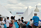 Bookfest fans and festival tents with the dome of the Capitol building in the background