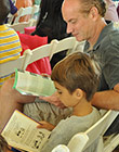 Father and son reading at the festival