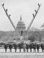 Photo of firetrucks forming a "V" with their ladders in front of the Capitol Building.