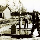 Photo: Well in the Village near Quang Ngai City, Republic of Vietnam.  One of over forty such hydro jet wells with hand pump completed by Navy Seabee technical assistance teams.  This well was installed by “Stat” 0903.  The plaque was placed by local residents, taken 1964.   NHHC Photograph Collection, NH 93808.