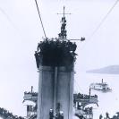 Photo: USS Pennsylvania (Armored Cruiser # 4).  Crewmen crowd the top of the ship's after smokestack, the boat cranes, foremast, and other vantage points on the morning of 18 January 1911, awaiting the arrival overhead of Eugene B. Ely's Curtiss biplane. Shortly afterwards, Ely landed on board, the first time an airplane landed on a warship.  Pennsylvania was then anchored in San Francisco Bay, California.  Photograph from the Eugene B. Ely scrapbooks.  NHHC Photograph Collection, NH 77515.