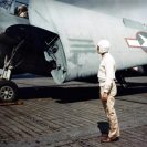 Photo: Squadron Leading Chief (in white cap and jersey), awaits readiness report from the pilot of a TBF on board a training escort carrier, circa mid-1943.  When he has reports from all the pilots, he will report to the Flight Deck Officer, 80-G-K-2629 (Color).