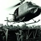 Photo: Republic of Vietnam.  Boat Captain, Boatswain’s Mate First Class Day, surrenders the Flight Deck of one of the Navy’s smallest flat tops to an Army HI Iroquis Helicopter after directing it to a landing.  The light aluminum platform is installed on an armored troop carrier (ATC) and is utilized mostly for medical evaluations and resupply during combat operations, July 1968.   Photographed by PH1 Dan Dodd.  NHHC Photograph Collection, L-File, USN 1136877.