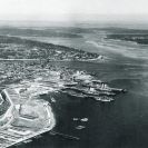 Photo: Puget Sound Navy Yard, Bremerton, Washington.  Aerial photograph taken in the mid-1930s.
Alongside the pier in center are the aircraft tender (ex-collier) Jason (AV-2), laid up in 1932 and sold in 1936, and the crane ship Kearsarge.  Also present are the aircraft carriers Lexington (CV-2) and Saratoga (CV-3).  NHHC Photograph Collection, NH 45236.