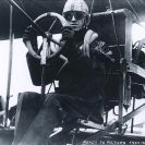 Photo: Aviator Eugene B. Ely.  Seated in his Curtiss pusher biplane on board USS Pennsylvania (Armored Cruiser # 4), during preparations for his return flight to Tanforan field, San Francisco, California, 18 January 1911.  Photograph from the Eugene B. Ely scrapbooks.  NHHC Photograph Collection, NH 77497.