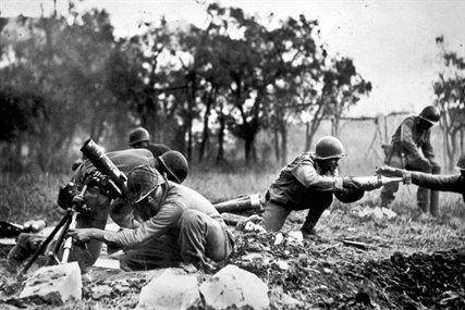U.S. soldiers pass ammunition as they fire on German troops near Massa, Italy, Nov. 1944. The soldiers are members of an African-American company assigned to the 92nd Division. This company is credited with liquidating several machine gun nests. 