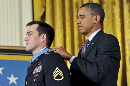 President Barack Obama presents the Medal of Honor to former Army Staff Sgt. Clinton L. Romesha during a ceremony at the White House in Washington, D.C., Feb. 11, 2013. Romesha received the Medal of Honor for his actions during a daylong firefight in Afghanistan in October 2009. 