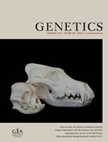 Two different size dog skulls seen on the cover of Genetics