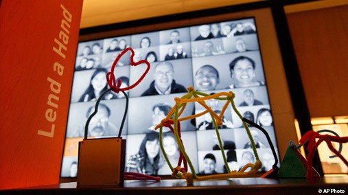 Toy models left by visitors of designs for products that could help solve world problems are seen in front of a wall of self-made photo portraits of other visitors at the Bill & Melinda Gates Foundation Visitors Center in Seattle, Washington, Jan. 24, 2012. [AP File Photo]