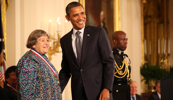 President Obama smiling standing next to Yvonne Brill in the White House.