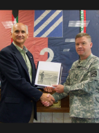 Lt. Gen. David Perkins receives scrapbook to be donated to Frontier Army Museum