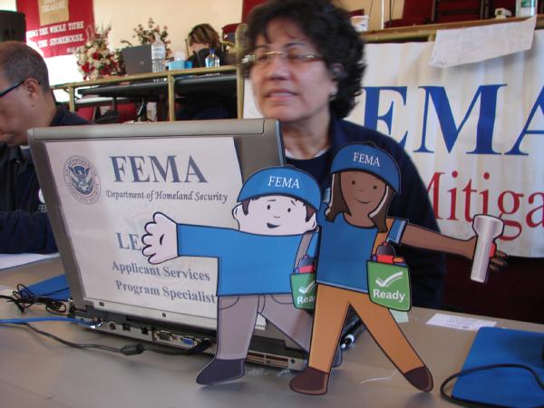 New York, N.Y., Dec. 15, 2012 -- Flat Stanley and Flat Stella visit a FEMA Disaster Recovery Center (DRC) specialist who is discussing mitigation best practices with Hurricane Sandy survivors. 