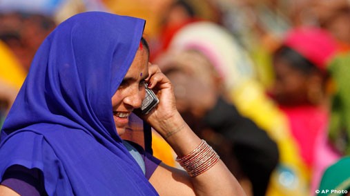 A woman talks on her mobile phone at an election rally in Faizabad, India, Feb. 2, 2012. [AP File Photo]