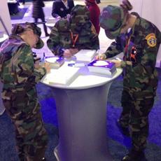 Members of the Central Arizona Young Marines, a youth organization supported by the Marine Corps League, write Thank You letters to Veterans at the American Legion booth during their visit to DC from Prescott, AZ.
