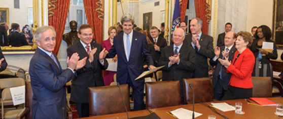 John Kerry is congratulated by colleagues.