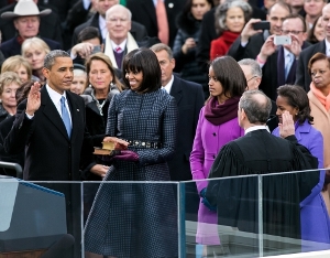 President Obama takes the oath of office while his family looks on