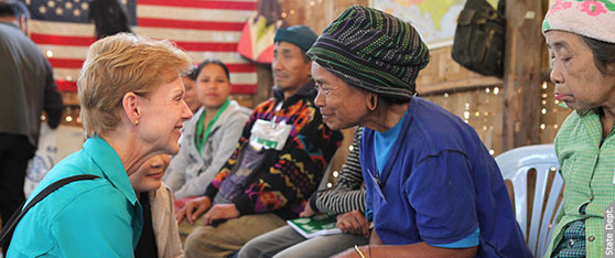 (January 30, 2013) Ambassador Kristie Kenney speaks to a Karenni refugee in Mae Hong Son Province who is learning about life in the U.S. before she departs for resettlement in America.