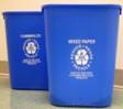 Picture of blue desk-side recycling bins.  One bin is for commingled and one is for mixed paper.  The have the NIH reduce, reuse, recycle logo in the center and are made of 100% post consumer recycled products.