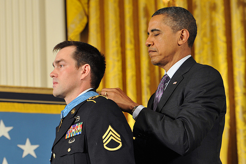 <p>President Barack H. Obama, right, awards the Medal of Honor to former U.S. Army Staff Sgt. Clinton L. Romesha during a ceremony at the White House in Washington, D.C., Feb. 11, 2013. Romesha received the award for actions during the Battle of Kamdesh at Combat Outpost Keating, Nuristan province, Afghanistan, Oct. 3, 2009. Romesha was a section leader with Bravo Troop, 3rd Squadron, 61st Cavalry Regiment, 4th Brigade Combat Team, 4th Infantry Division at the time of the battle. (U.S. Army photo by Leroy Council/Released)</p>