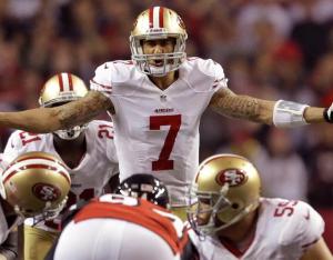 San Francisco 49ers quarterback Colin Kaepernick signals to the team’s line during the second half of a playoff game. (AP Images)