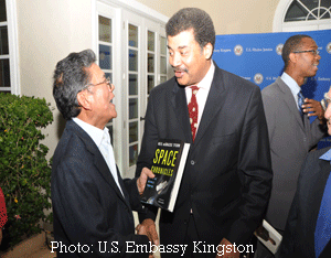 two men chat while standing