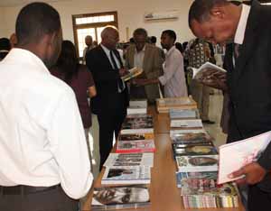 Group of people looking at books. (Photo Credit: State Department)