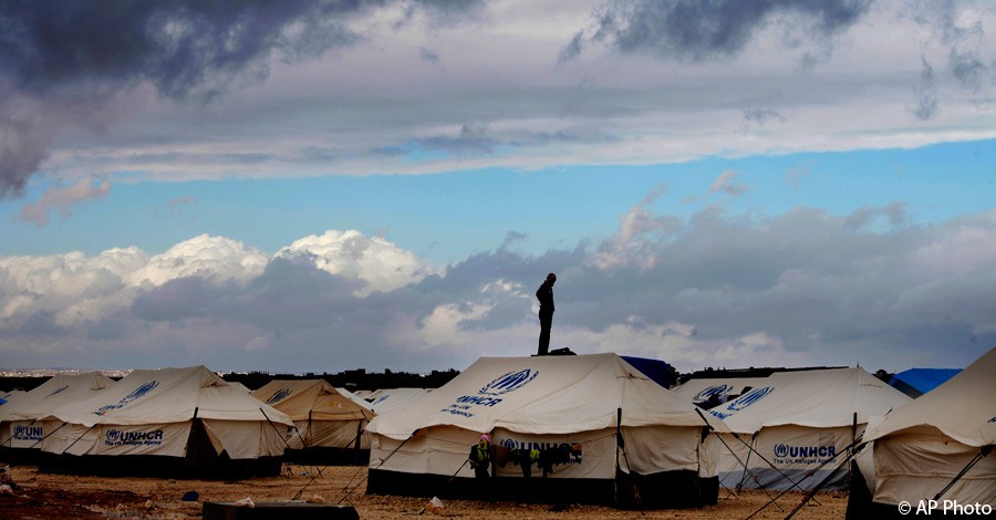 A Syrian refugee stands on top of a water tank at Zaatari refugee camp, near the Syrian border in Mafraq, Jordan, January 9, 2013. [AP File Photo]