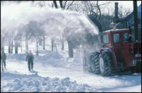 Photo: A snow thrower clearing a street.