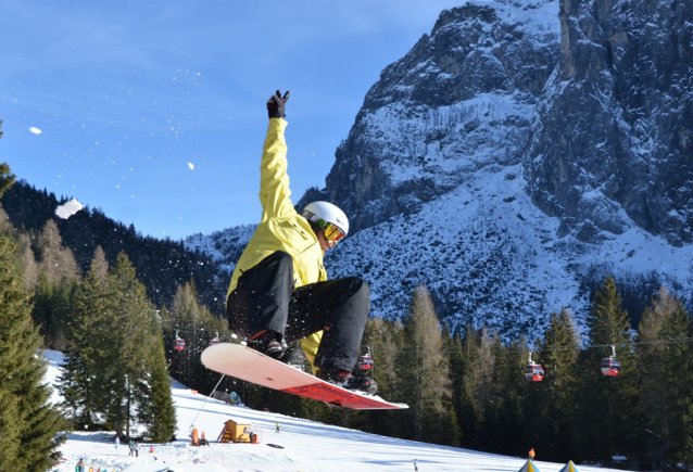Chris Wolff, Vicenza Outdoor Recreation snowboard instructor, flies off a jump.