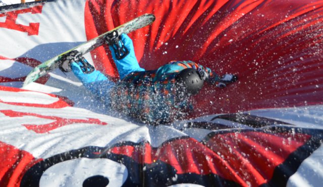 Reid Erickson, Vicenza Outdoor Recreation snowboard instructor, lands on a giant pillow after jumping off a 15 foot high jump.