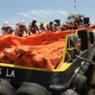 workers on boat pull boom