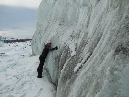 Christy Hansen hugs the Russell glacier, part of the Greenland Ice Sheet. Credit: Christy Hansen