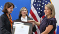 Three women,one is receiving a certificate (U.S. Statet Department)