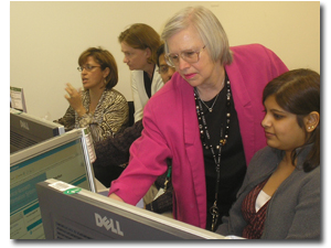Instrucotr helping a participant while standing in front of a computer monitor