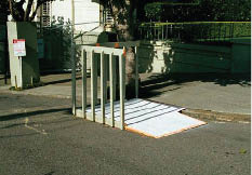 A temporary movable ramp and landing constructed of wood that can be set in a curb lane to provide access at a pedestrian detour.  The landing is enclosed by railings at its street edges.