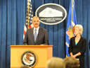 Attorney General Eric Holder delivers remarks while Health and Human Services Secretary Kathleen Sebelius and FBI Associate Deputy Director Kevin Perkins look on.