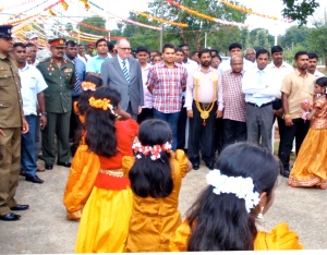 William Weinstein, Deputy Chief of Mission, U.S. Embassy, and Hon. Namal Rajapaksa, MP, are greeted by dancers at the entrance to Oddusuddan Divisional Hospital in Mullaitivu District, during the official opening of the hospital. (State Dept.)