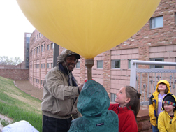 Forecaster demonstrates a weather ballon launch.