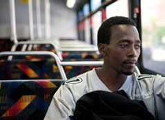 Image of a man sitting on a bus.