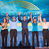 Photo of several people standing with arms raised in front of the Celebration of Science logo.