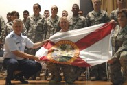 lorida Air National Guard Commander Brig. Gen. Joseph Balskus (left) and 290th JCSS Commander Lt. Col. Loretta Lombard (right) present a State of Florida flag to Maj. Rick Basting (center) and the deploying members of the 290th JCSS during a ceremony at MacDill Air Force Base, Aug. 16, 2009. Photo by Tech. Sgt. Thomas Kielbasa