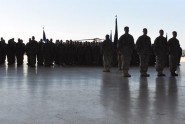 The silhouettes of Soldiers from the Florida Army National Guard's 1st Battalion, 111th Aviation Regiment, stand out against the open hangar door of the Aviation Support Facility in Jacksonville, Fla., Aug. 29, 2011. More then 240 Soldiers from the unit deployed in support of Operation New Dawn in Iraq. Photo by Master Sgt. Thomas Kielbasa