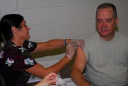 Col. John Grote, the Army National Guard Chief Surgeon, receives his influenza vaccine while visiting Soldiers from the Florida National Guard, Sept. 16, 2011. Soldiers from the Florida National Guard began receiving flu shots to mark the beginning of the 2011 flu season.